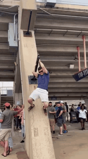 a man climbs up a wall with a sign that says 110-111