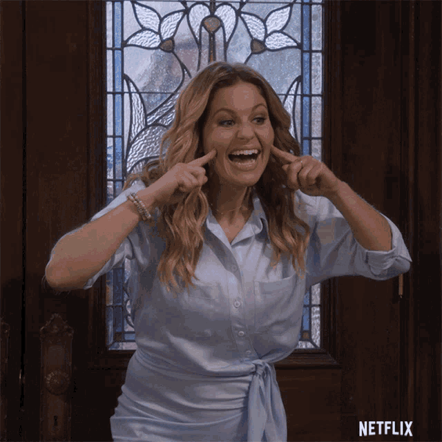 a woman making a funny face in front of a netflix logo