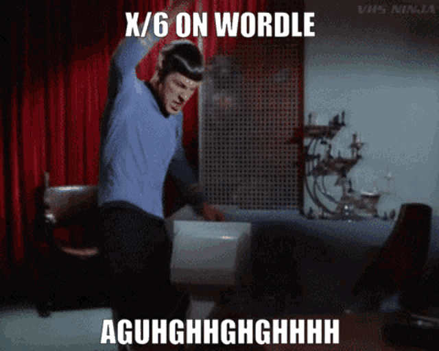 a man in a blue shirt stands in front of a red curtain with the words x / 6 on wordle