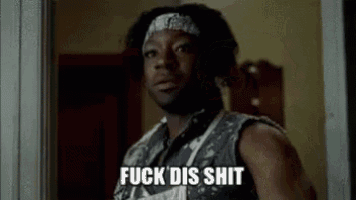 a man with a bandana on his head is standing in front of a door and says `` fuck dis shit '' .
