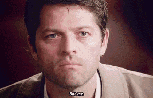 a close up of a man 's face with the words bite me written on it .
