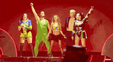 a group of people standing on a stage with a red background that says rb0jd