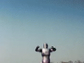 a man in a superhero costume is jumping in the air .