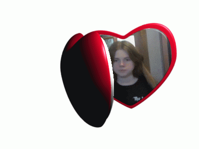 a heart shaped mirror with a girl 's reflection and the word the on it