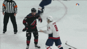 a hockey player with the number 8 on his jersey fights another player