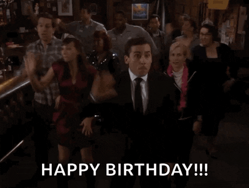 a man in a suit and tie is dancing in front of a crowd with the words happy birthday written below him