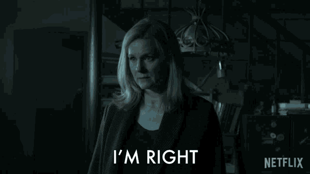 a woman is standing in a dark room and says you know i 'm right