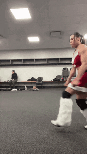 a man in a santa claus outfit is running in a room