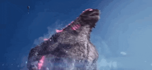 a monster is standing in the water with its mouth open and glowing red .