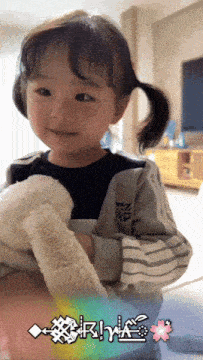 a little girl is holding a stuffed animal in her hands with the word cherry written on the bottom