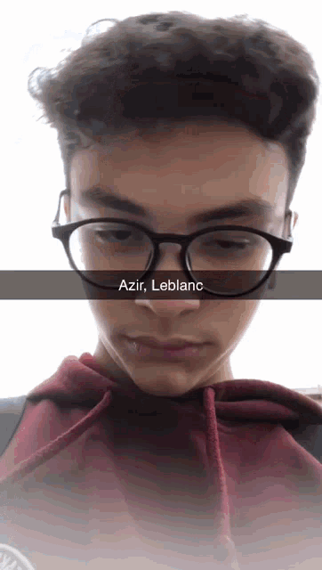 a young man wearing glasses with the name azir leblanc written on the bottom