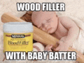 a baby is sleeping next to a can of wood filler and a rolling pin .