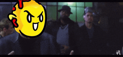 a group of men are standing in a dark room with a yellow smiley face behind them