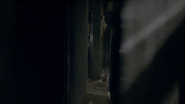 a woman in a white dress is standing in a hallway