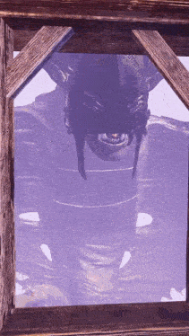 a picture of a monster in a wooden frame with a purple sky in the background