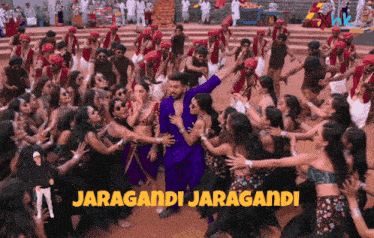a group of people are dancing in front of a sign that says ' jaragamdi jaragamdi '
