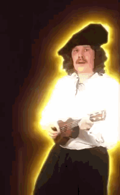 a man with a mustache is holding a guitar and wearing a black hat
