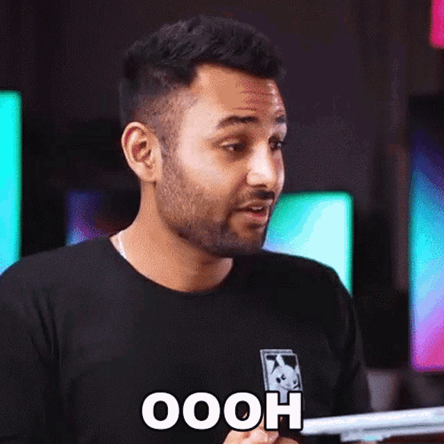 a man with a beard is wearing a black shirt that says oooh