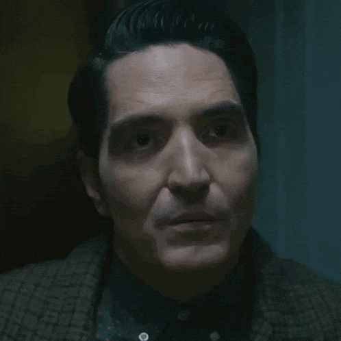 a close up of a man 's face with a serious look on his face