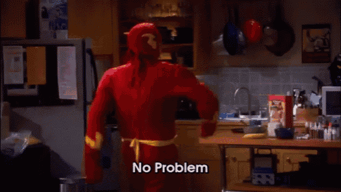 a man in a flash costume is standing in a kitchen and says no problem