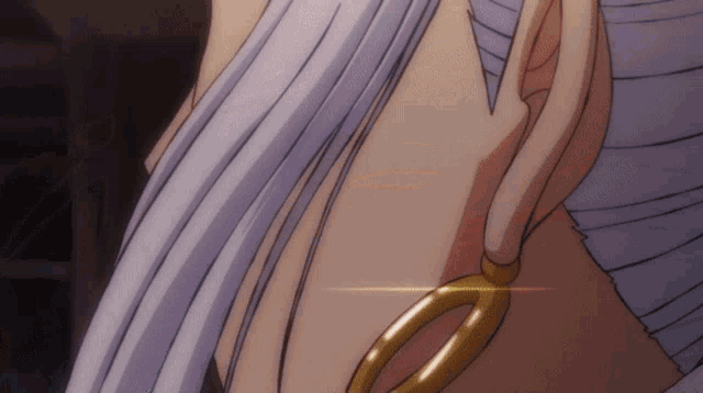 a close up of a person 's ear with a pair of scissors