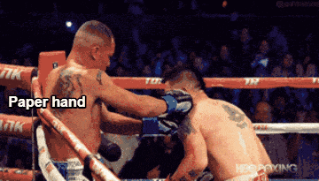 two men in a boxing ring with the words paper hand on the top