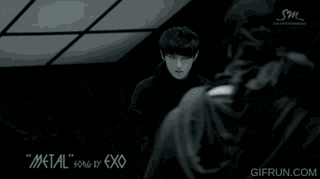 a metal song by exo is being played in a dark room