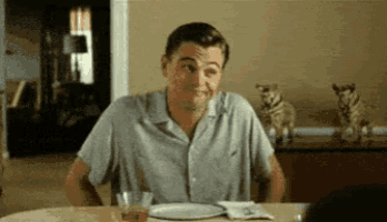 a man is sitting at a table with a plate of food .