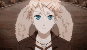 a young boy with blonde hair and blue eyes is standing in front of a circle with writing on it .