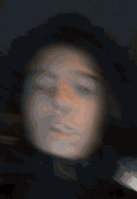 a blurry picture of a person with their eyes closed