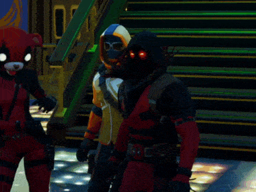 a man in a deadpool costume stands next to another man