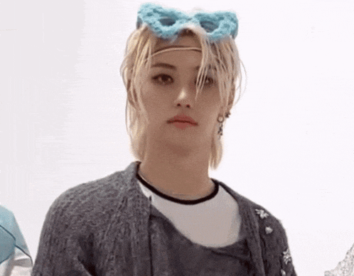 a close up of a person wearing a headband and a cardigan .