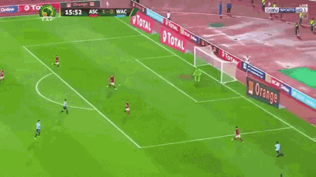 a soccer game is being played on a field with ads for total and orange along the sidelines