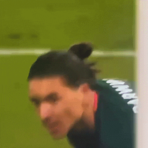 a man in a green jersey with the number 15 on it