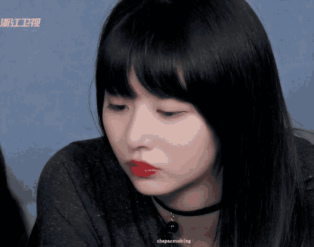 a close up of a woman 's face with chinese writing on the bottom left