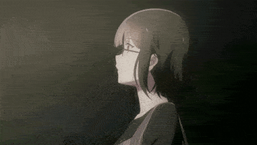 a girl with short hair and glasses looks down
