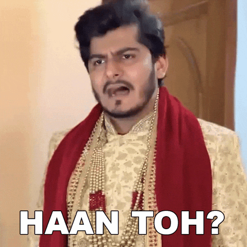 a man wearing a pearl necklace and a red scarf says haan toh ?