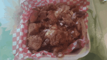 a container of food with checkered paper on it