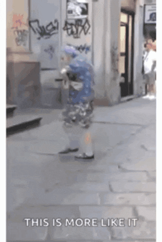 a person walking down a street with the words this is more like it