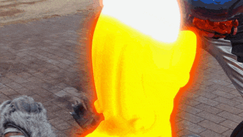 a person is standing on a brick sidewalk with a yellow flame coming out of their leg