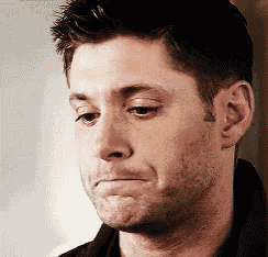 a close up of a man 's face making a sad face