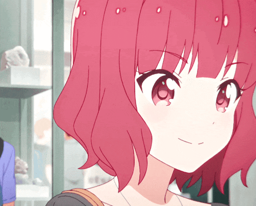 a girl with red hair is smiling and looking at the camera