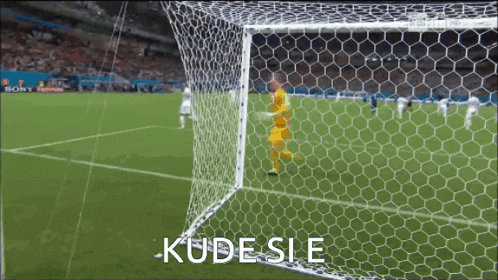 a soccer goalie stands in front of a soccer net with the words kude sie written on the bottom