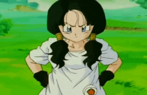 a cartoon girl with pigtails is standing in a field with her hands on her hips .