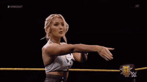 a woman in a wrestling ring with the letters nxt on the bottom