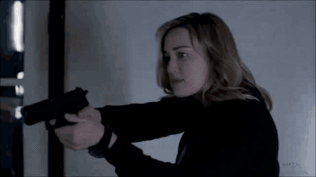 a woman is pointing a gun at the camera with a watermark that says mba