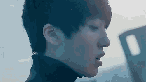 a close up of a person 's face with their eyes closed and their mouth open .