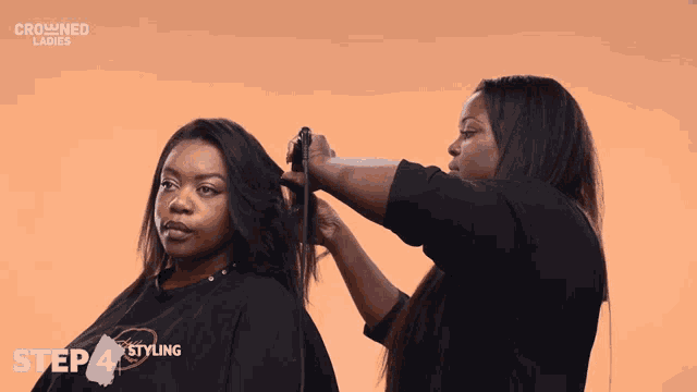 a woman is getting her hair styled by a crowned ladies hairdresser