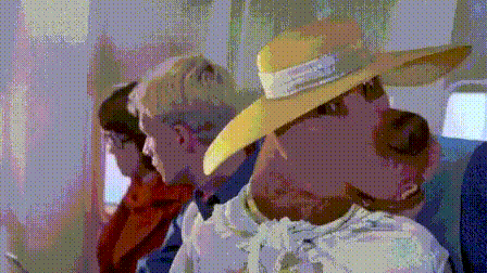 a pixelated image of a man wearing a cowboy hat and a white shirt