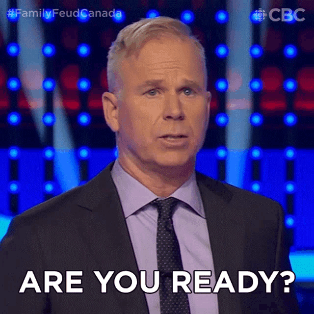 a man in a suit and tie is saying are you ready